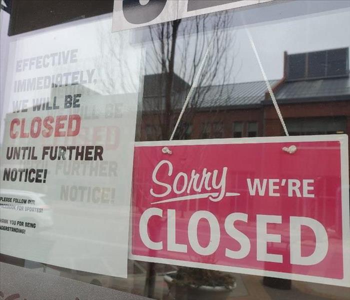 business door with sorry we're closed sign