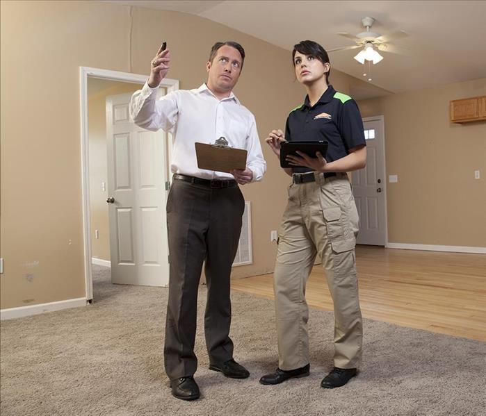 Insurance Adjuster working with SERVPRO® employee on a property damage claim